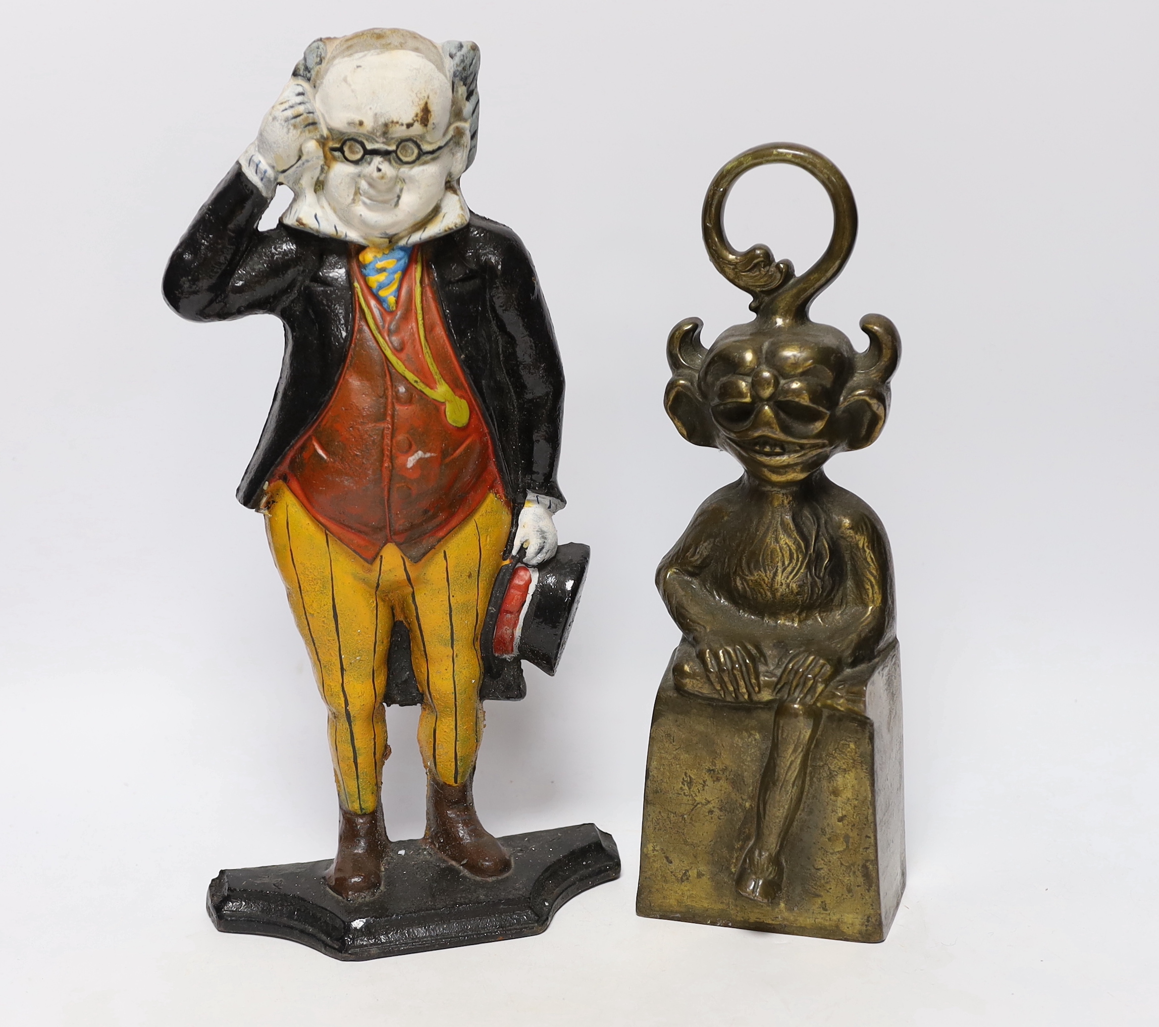 Two door stops including a cast iron ‘Mr Pickwick’ and brass Lincoln Imp, largest 36cm high